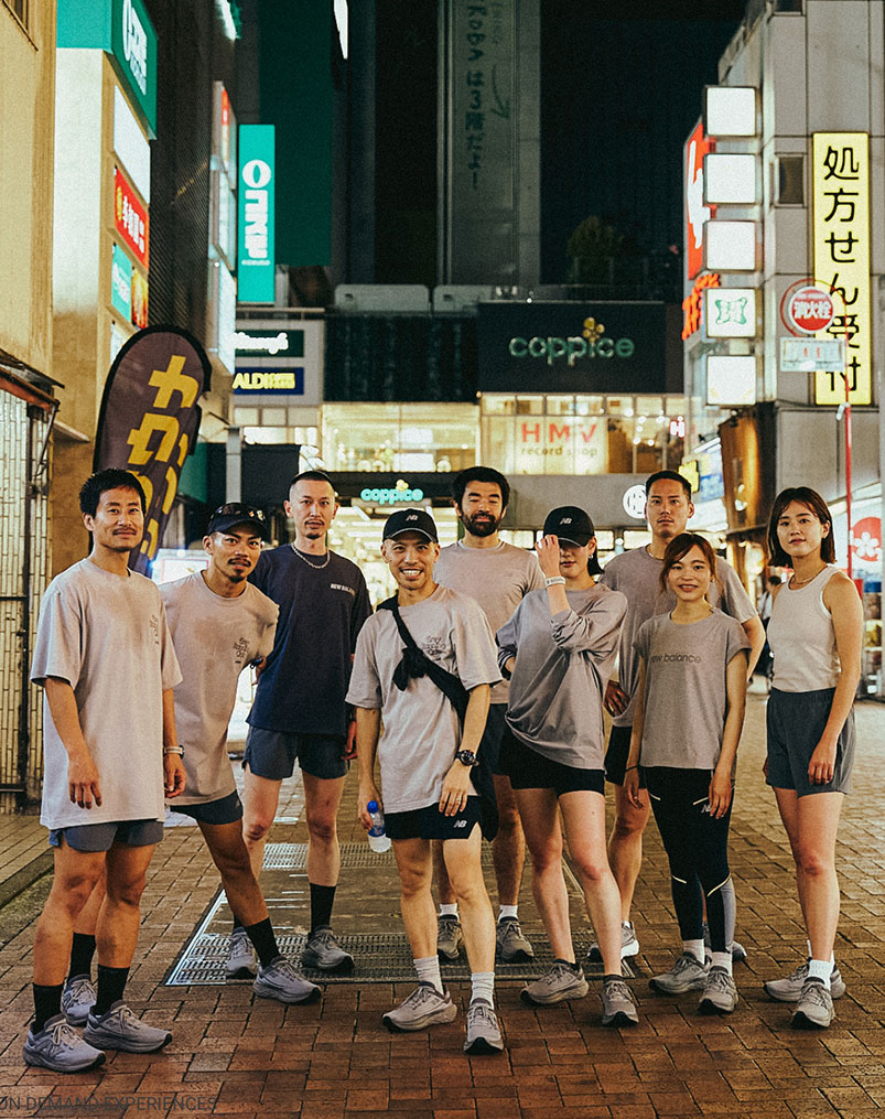 Run crew posing on a Tokyo street at night